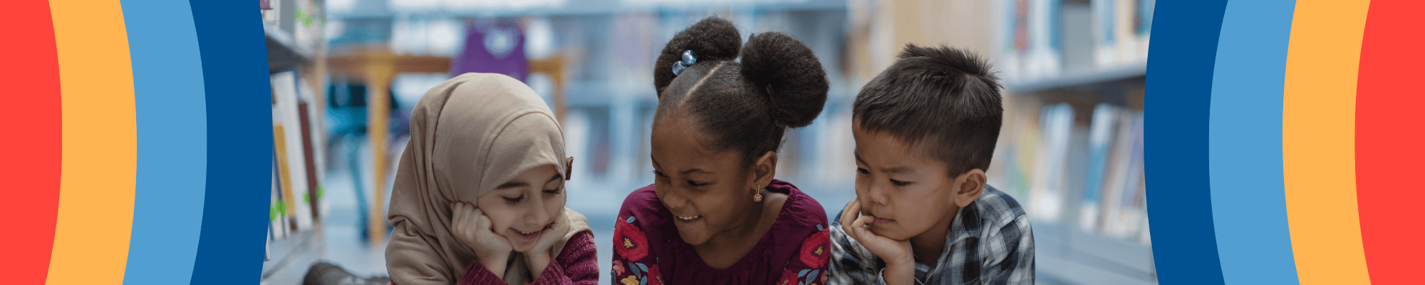 Three children reading a book